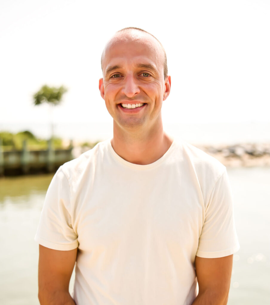 a man standing in front of a body of water