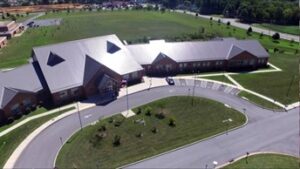 an aerial view of a building with a parking lot