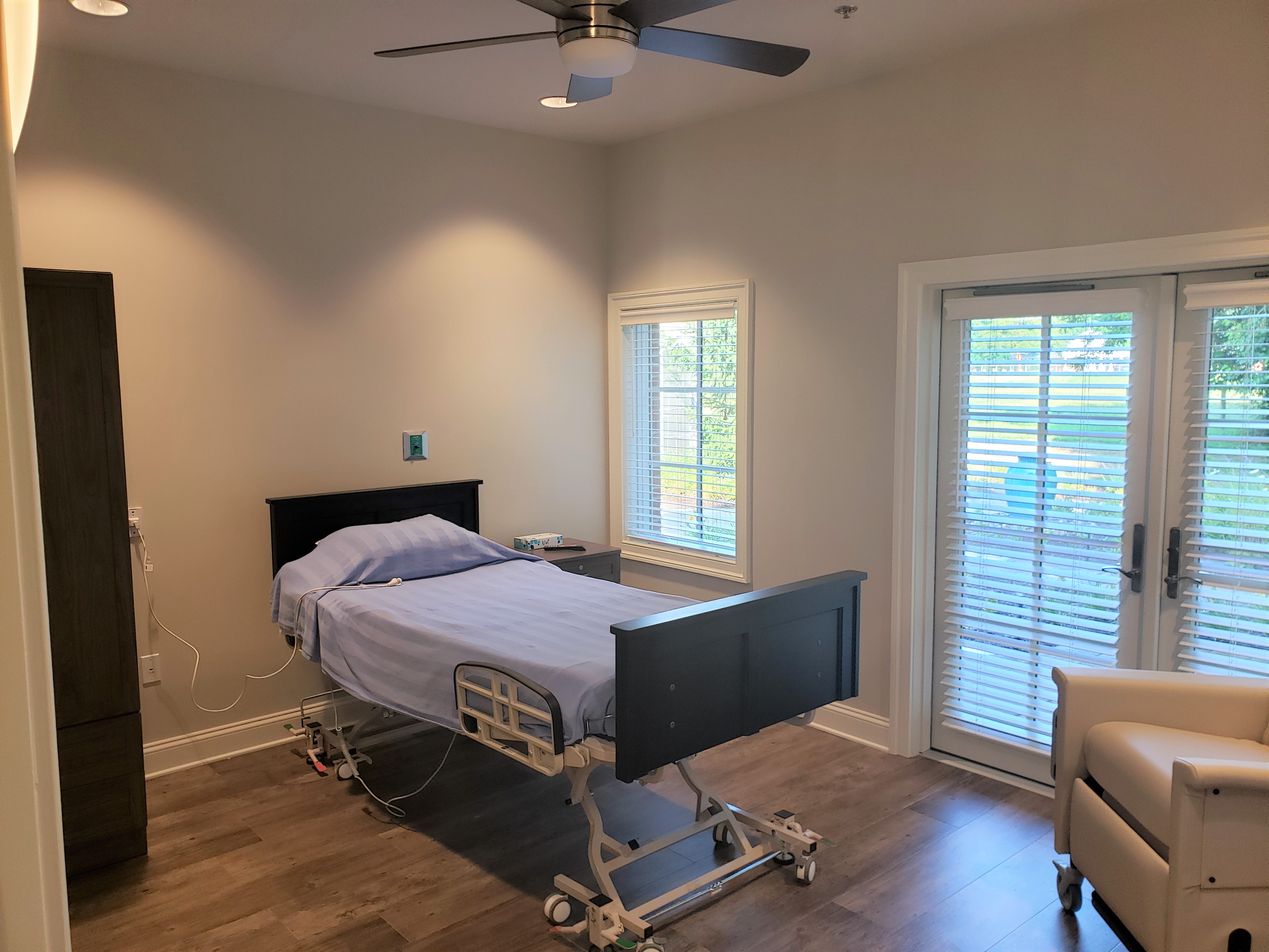 a hospital room with a bed and a chair