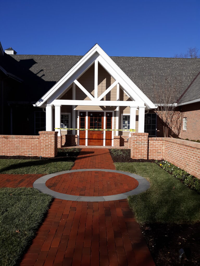 a house with a brick walkway leading to the front door