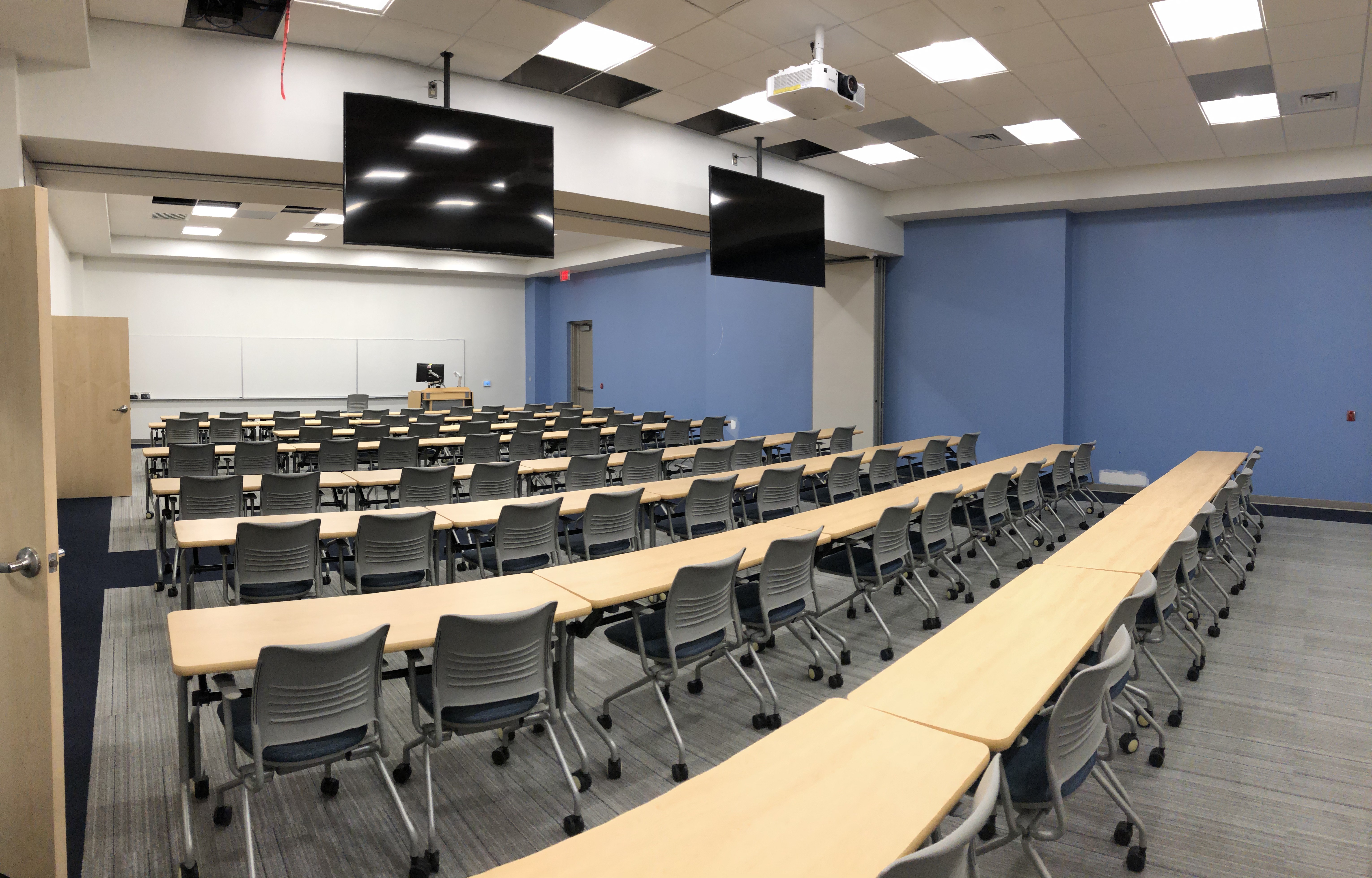 a large room with rows of tables and chairs