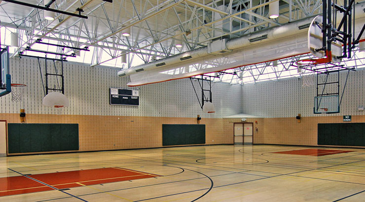 an empty basketball court with a basketball hoop