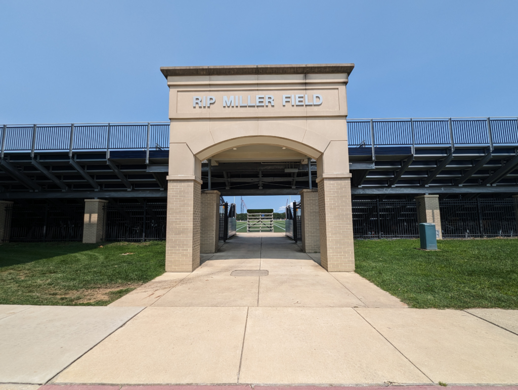 the entrance to a baseball stadium with a blue sky in the background