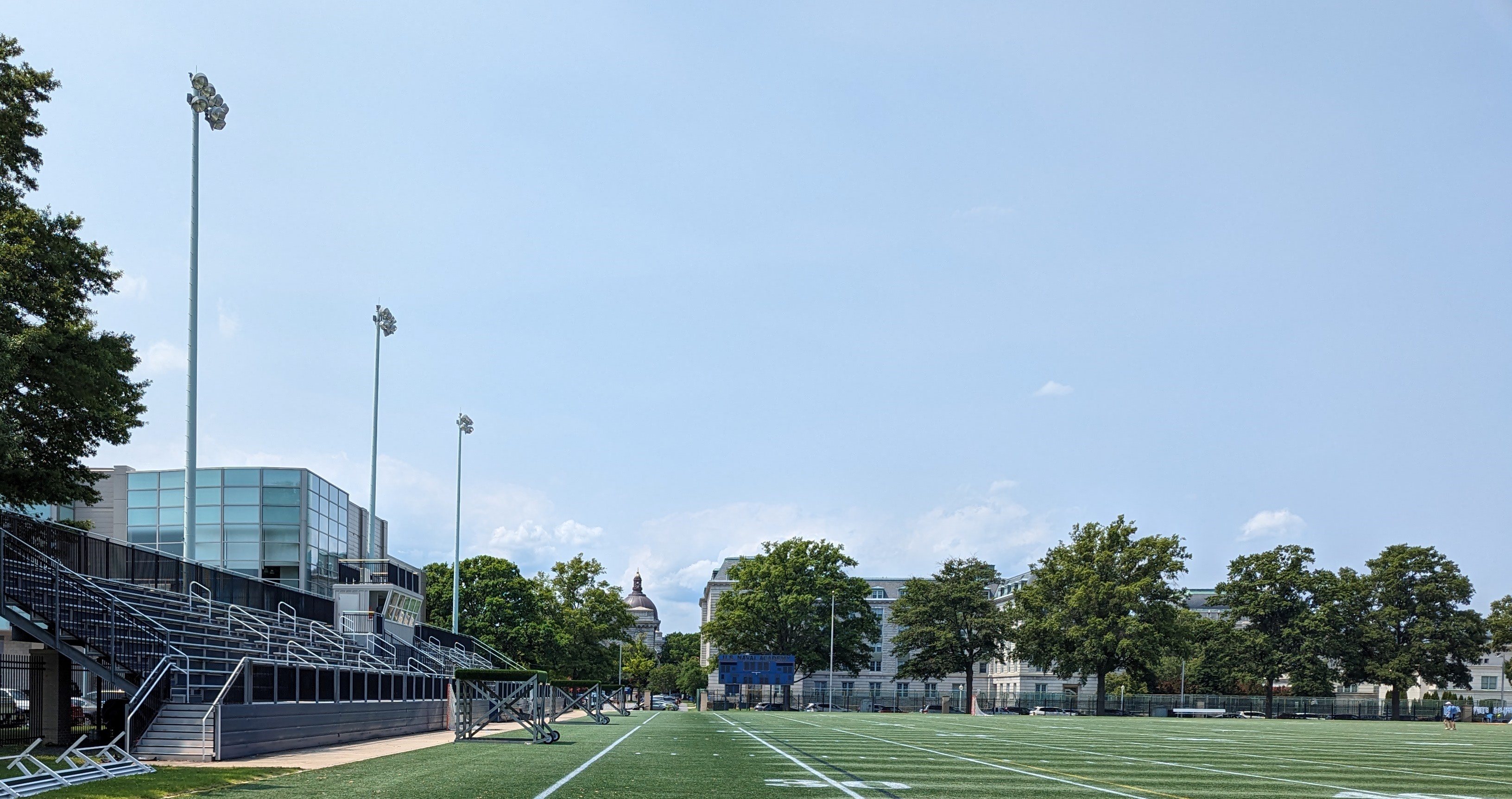 an empty football field in front of a building