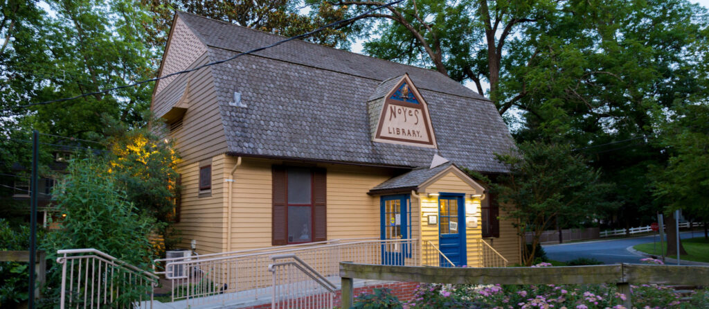 a small yellow house with a blue door