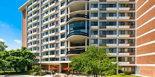 an apartment building with a parking lot in front of it