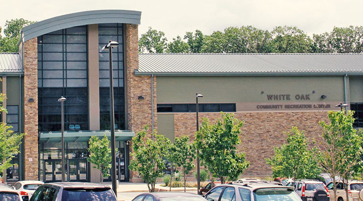 a parking lot with cars parked in front of a building