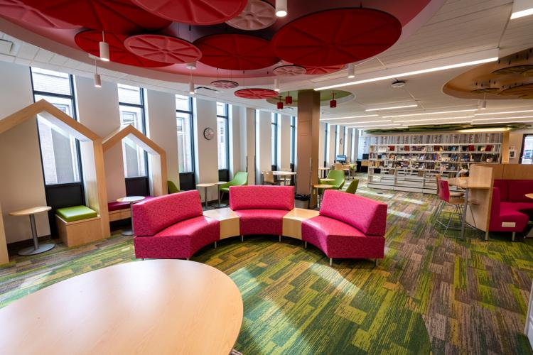 a library filled with lots of books and furniture