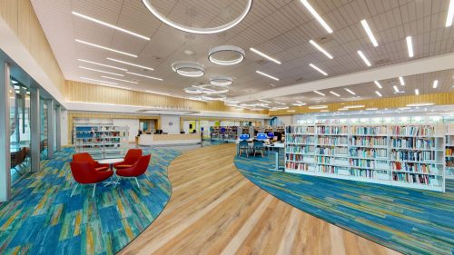 a library filled with lots of books and chairs